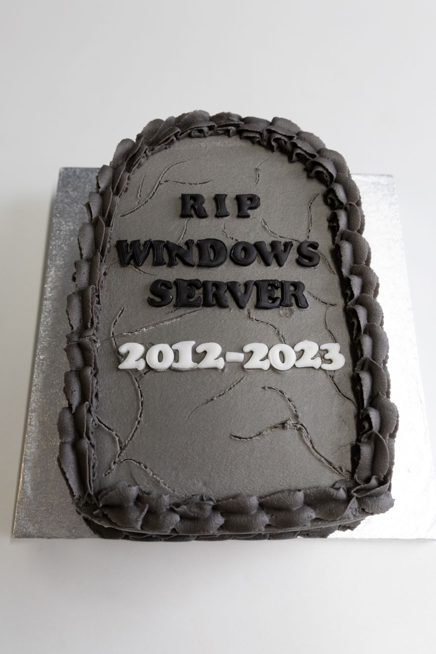 Tombstone shaped cake labelled "RIP Windows Server 2012-2023"